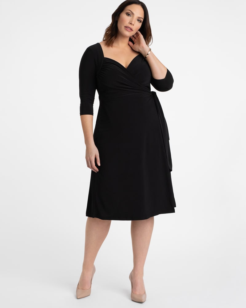 Front of a model wearing a size 0X Chrystie Knit Wrap Dress in BLACK NOIR by Kiyonna. | dia_product_style_image_id:227347